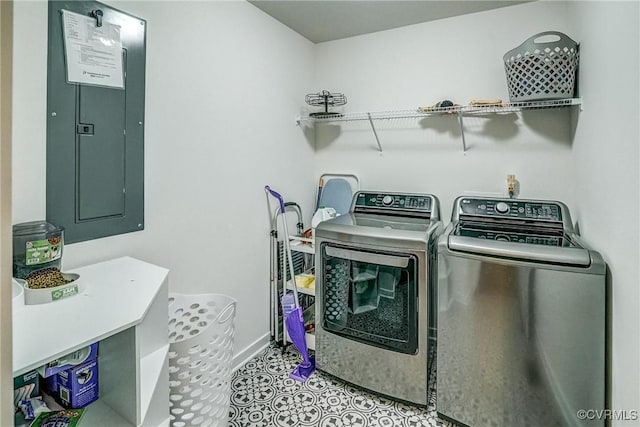 clothes washing area with washer and clothes dryer and electric panel