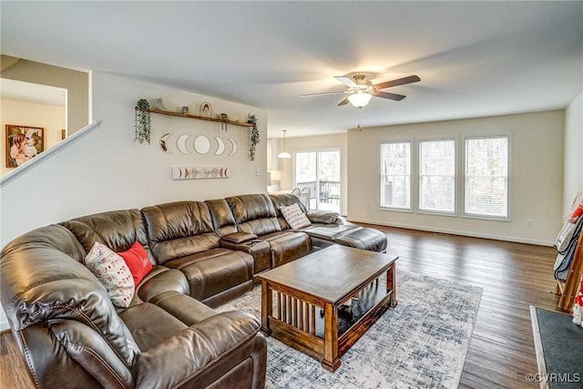 living room with ceiling fan, a wealth of natural light, and dark hardwood / wood-style flooring