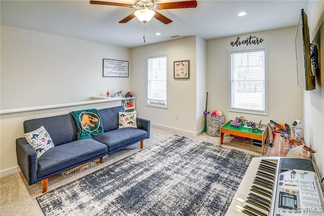 carpeted living room with ceiling fan