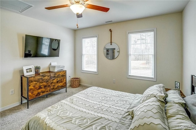 carpeted bedroom featuring ceiling fan and multiple windows