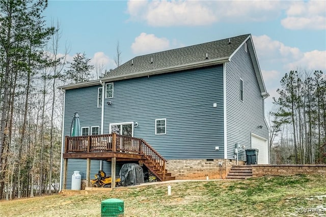 rear view of property featuring a deck, a yard, and a garage