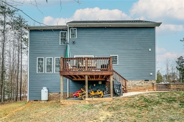 rear view of house with a deck and a yard