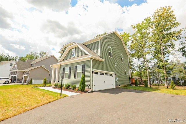 view of front of house with a garage and a front yard