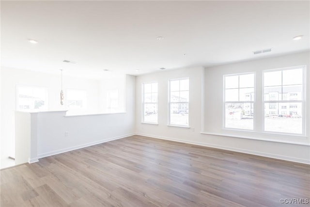 unfurnished room featuring light hardwood / wood-style flooring and a wealth of natural light