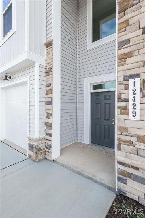 view of exterior entry featuring a garage