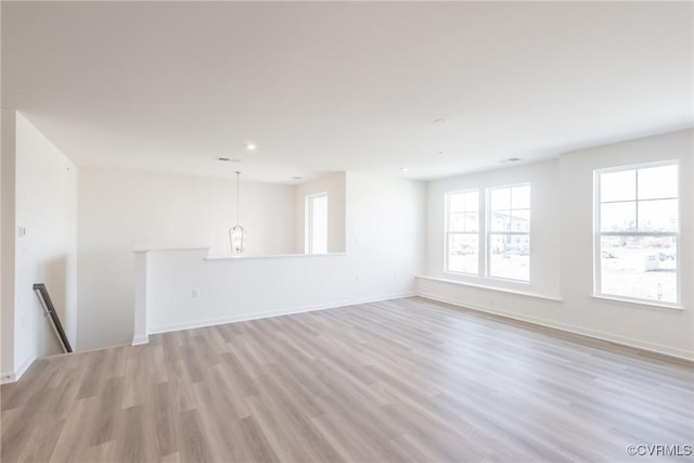 empty room with light hardwood / wood-style flooring