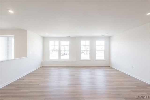 spare room featuring light hardwood / wood-style flooring