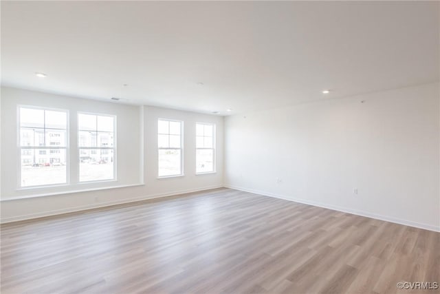 unfurnished room with light wood-type flooring