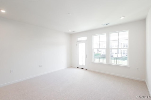 carpeted empty room featuring a healthy amount of sunlight