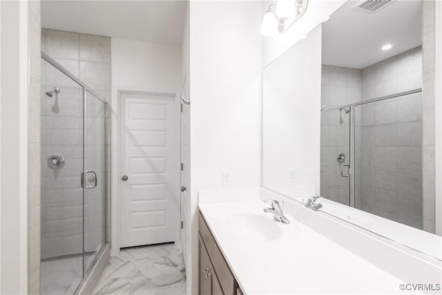 bathroom featuring vanity and a shower with shower door