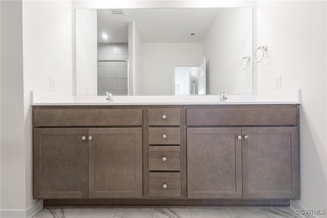 bathroom with a shower and vanity