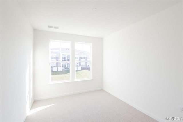 empty room with light colored carpet