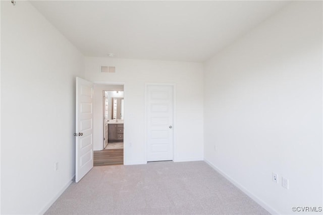 unfurnished bedroom featuring light colored carpet