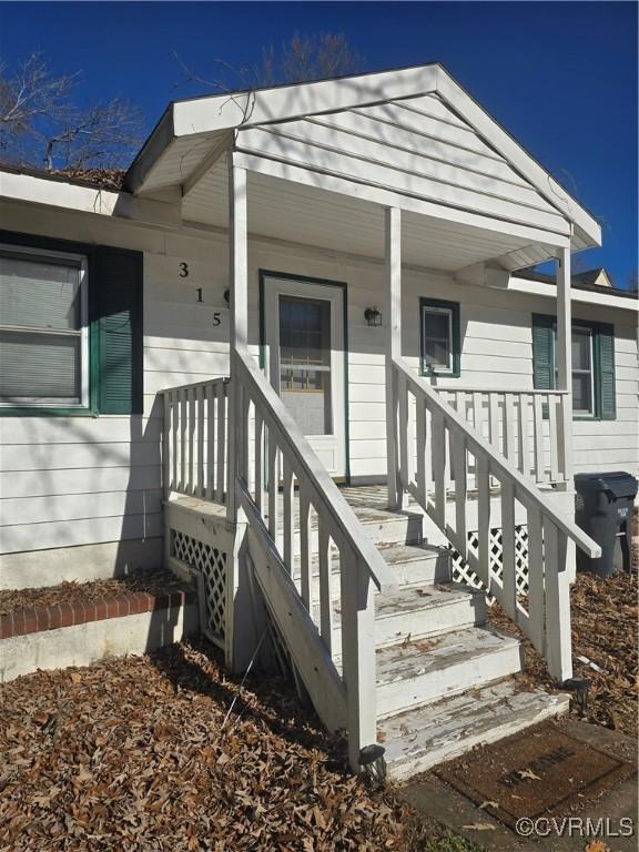 view of exterior entry with covered porch