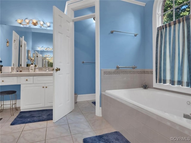 bathroom featuring vanity, tile patterned floors, and tiled bath