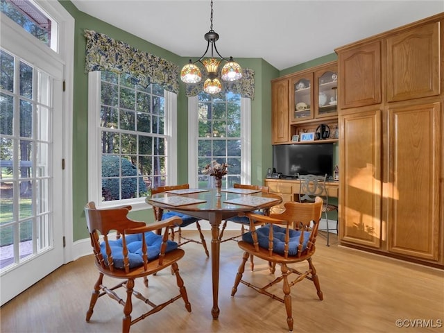 dining area featuring light hardwood / wood-style floors and a chandelier