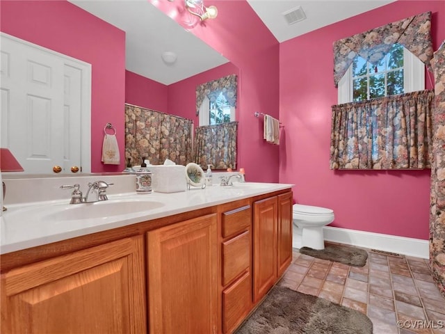 bathroom featuring toilet, curtained shower, and vanity