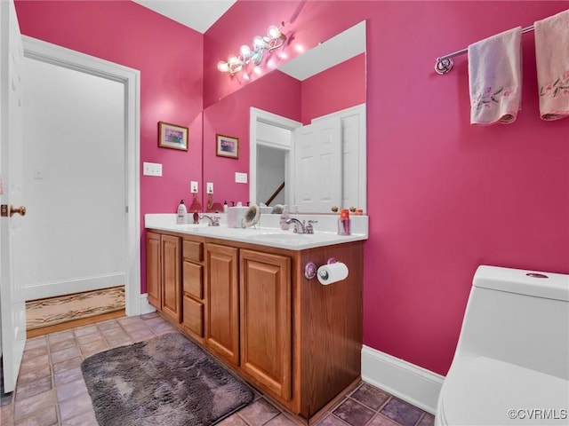 bathroom featuring toilet and vanity