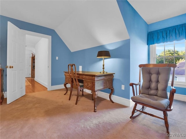 office area with vaulted ceiling and carpet flooring