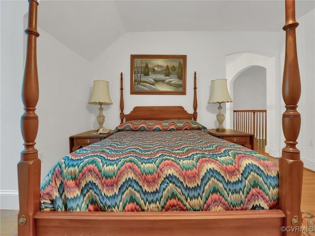 bedroom featuring hardwood / wood-style floors and vaulted ceiling