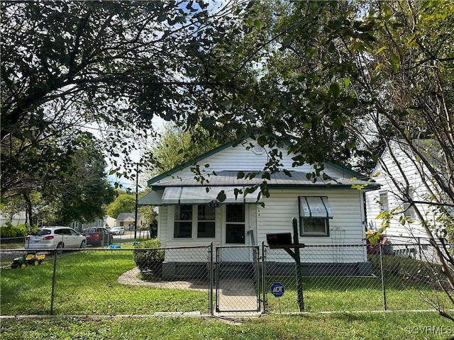 bungalow-style home with a front lawn