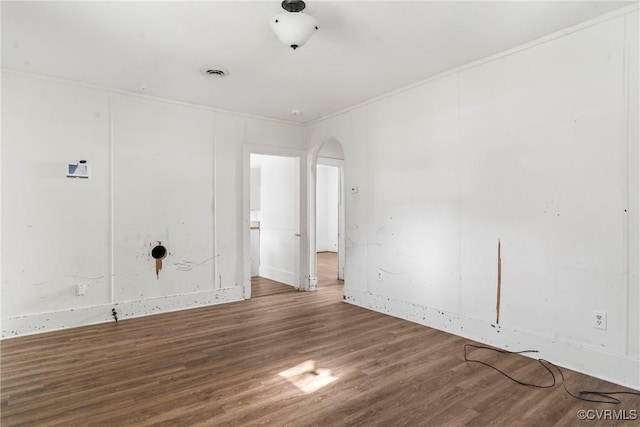 spare room with ornamental molding and hardwood / wood-style flooring