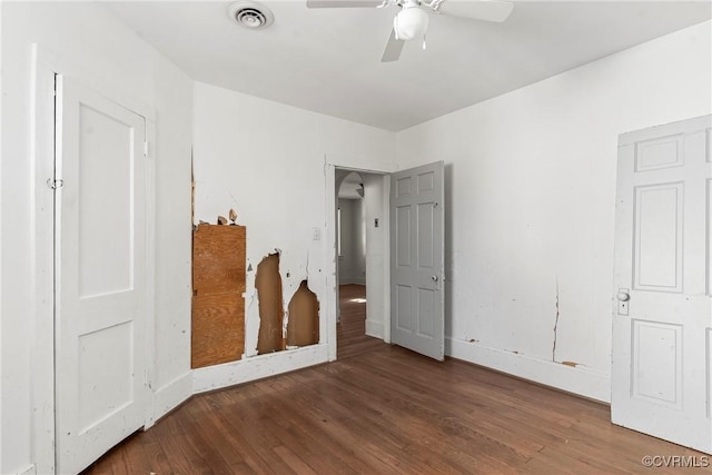 empty room with ceiling fan and dark hardwood / wood-style floors