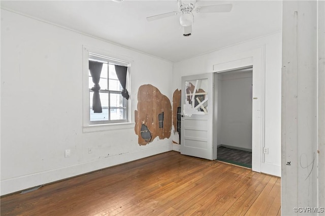 unfurnished bedroom with ceiling fan and hardwood / wood-style flooring