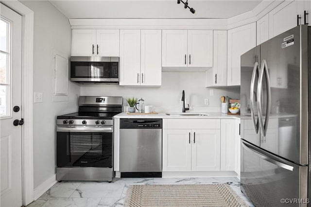 kitchen with sink, white cabinetry, and appliances with stainless steel finishes