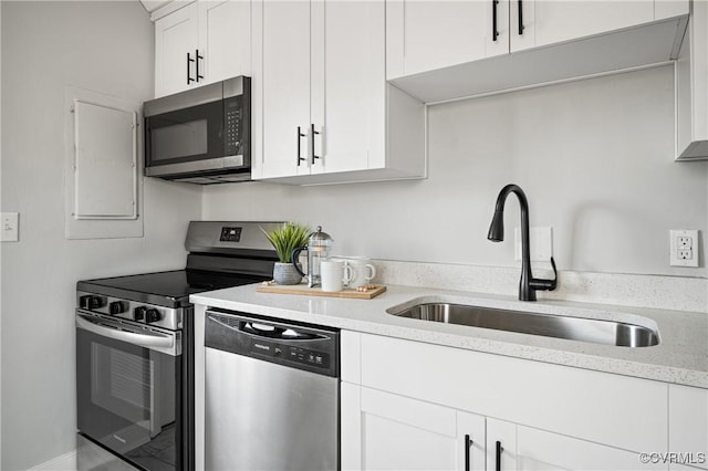 kitchen featuring sink, stainless steel appliances, and white cabinetry