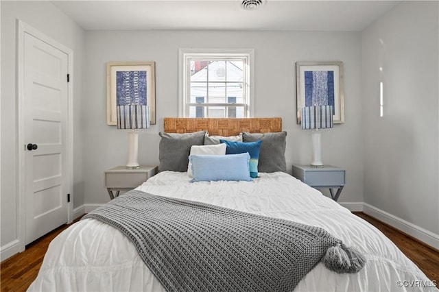 bedroom with dark wood-type flooring