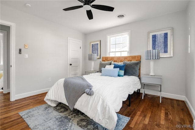 bedroom with ceiling fan and dark wood-type flooring