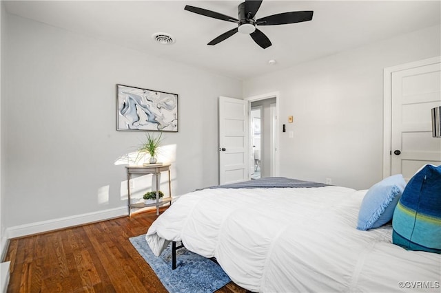 bedroom featuring ceiling fan and dark hardwood / wood-style floors