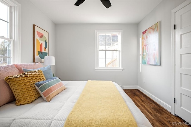 bedroom with ceiling fan and dark hardwood / wood-style floors