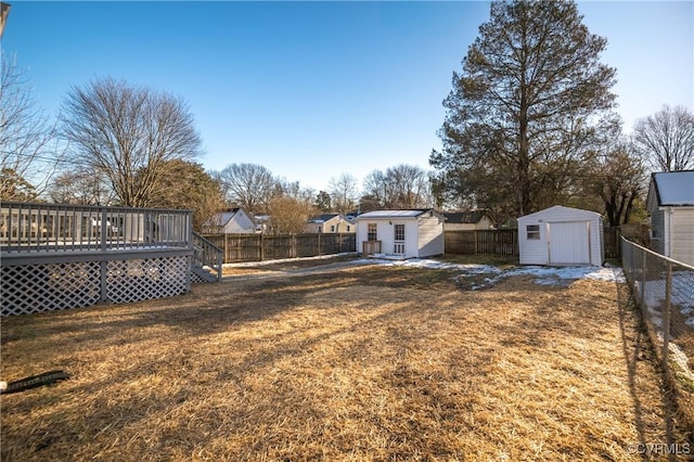 view of yard featuring a deck and a shed