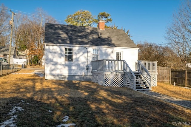 back of property with a lawn and a wooden deck