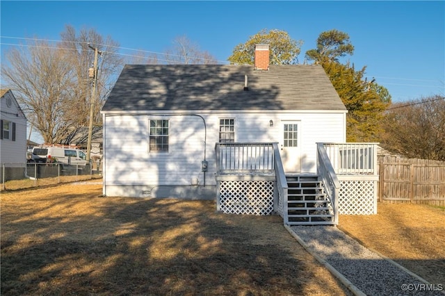 back of house featuring a yard and a wooden deck