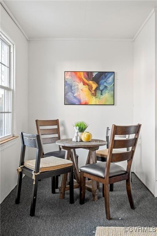 dining room featuring carpet floors and crown molding