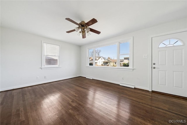 entrance foyer featuring ceiling fan, a healthy amount of sunlight, and dark hardwood / wood-style floors