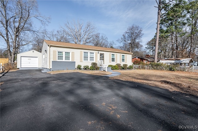 view of front of home with a garage and an outdoor structure