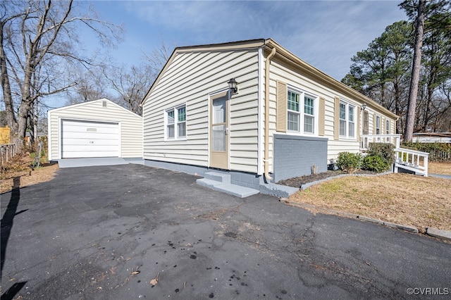 view of property exterior featuring an outbuilding and a garage