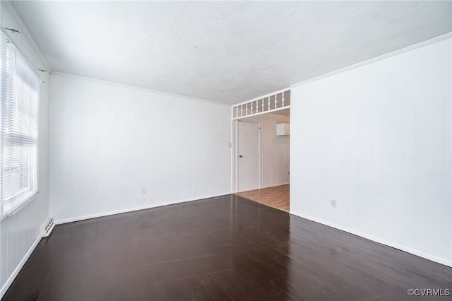 empty room featuring crown molding and dark hardwood / wood-style floors