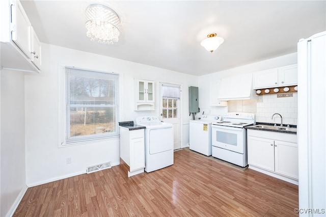 kitchen with white electric stove, white cabinetry, sink, and washer / clothes dryer