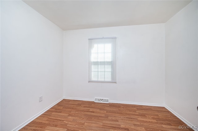 empty room with light hardwood / wood-style flooring