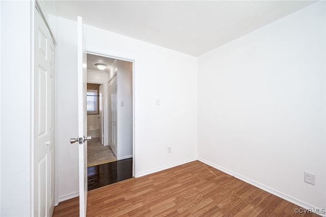 spare room with wood-type flooring