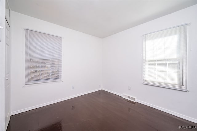 empty room with dark wood-type flooring