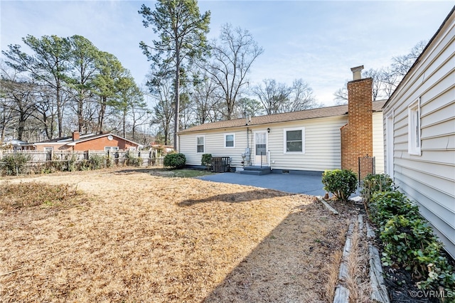 rear view of property with cooling unit and a patio