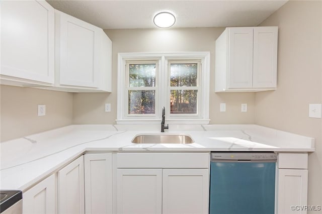 kitchen featuring light stone counters, white cabinets, dishwasher, and sink