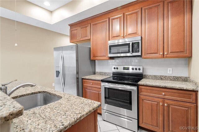 kitchen featuring tasteful backsplash, sink, stainless steel appliances, light tile patterned floors, and light stone counters