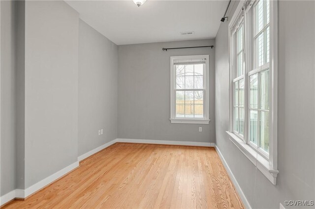 unfurnished room with light wood-type flooring